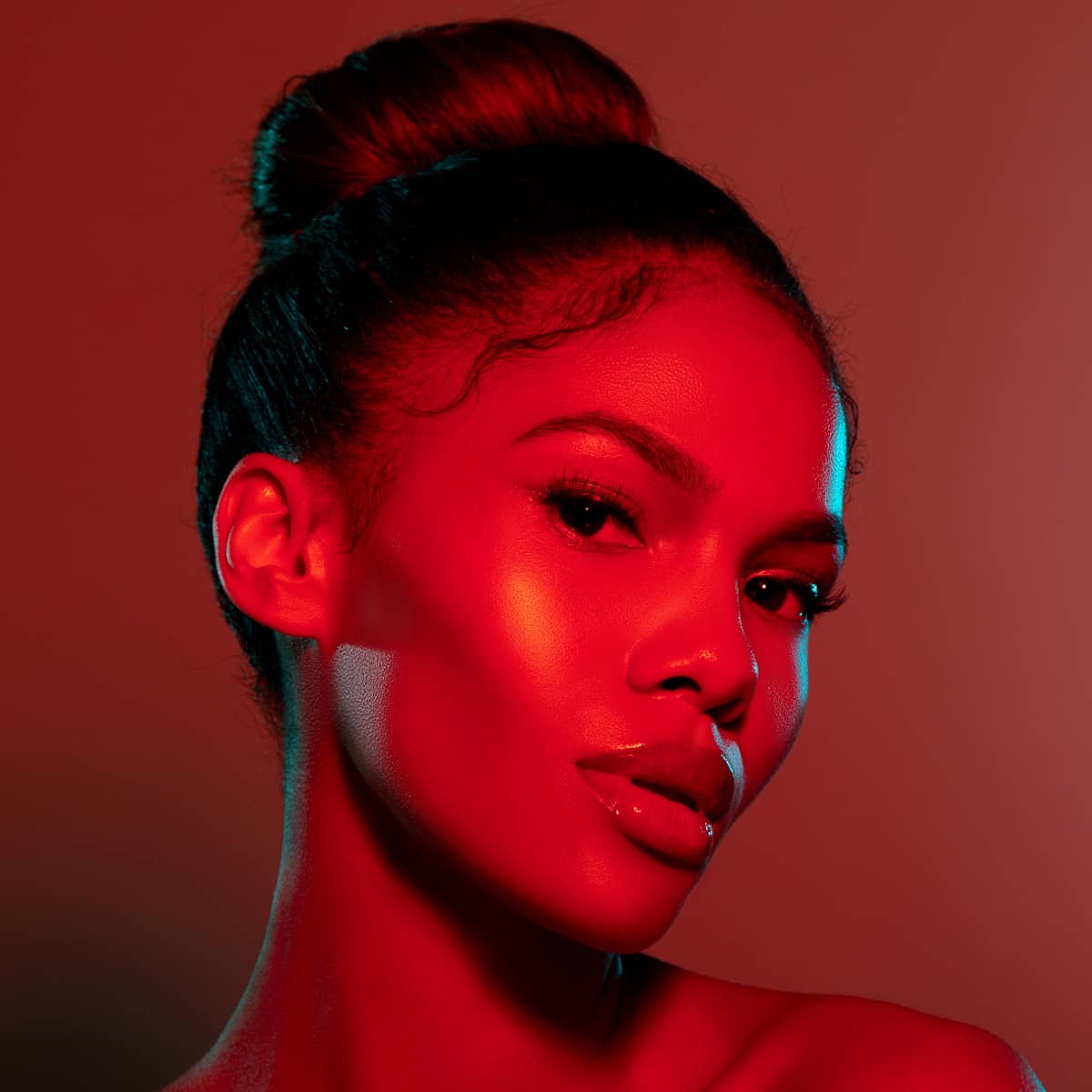 An image of a woman with red light therapy on her face