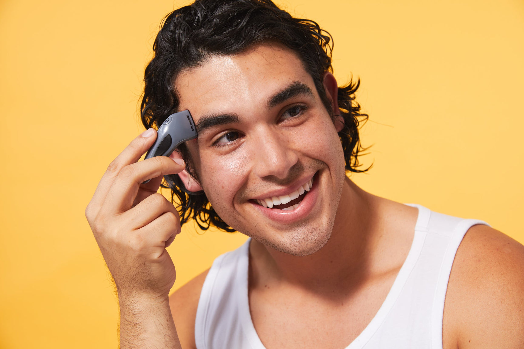 An image of a man using the blue light therapy device