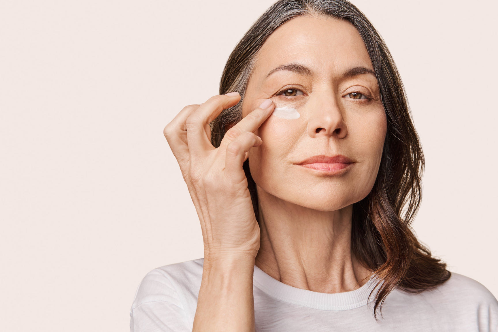 An image of a woman applying toner to her face