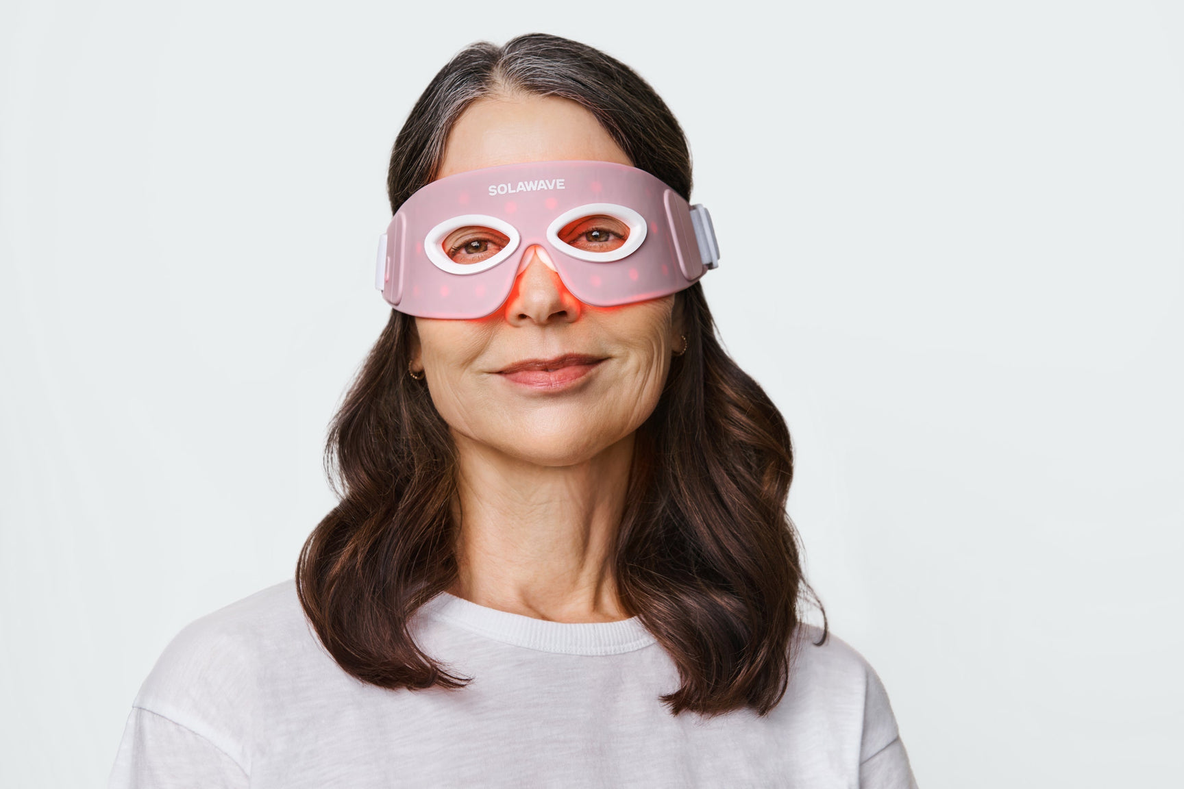 An image of a woman wearing red light eye mask