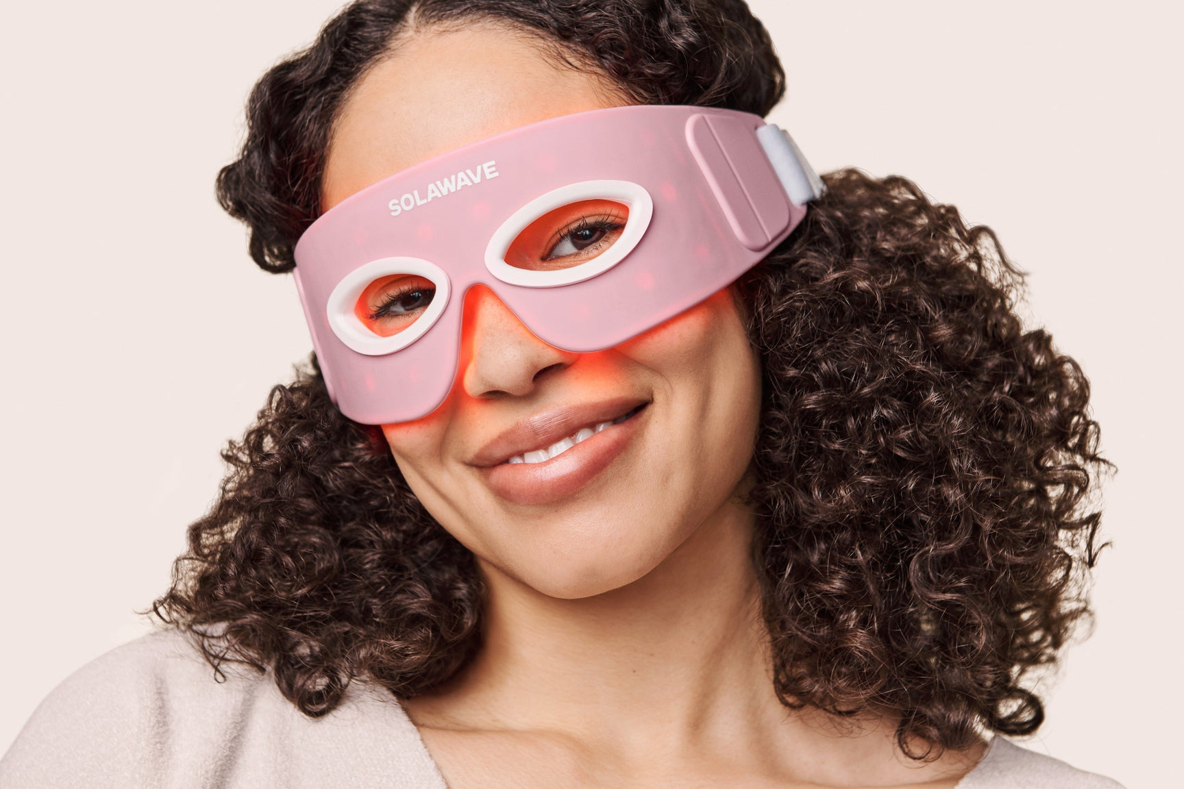 An image of a woman using the Solawave red light therapy eye mask