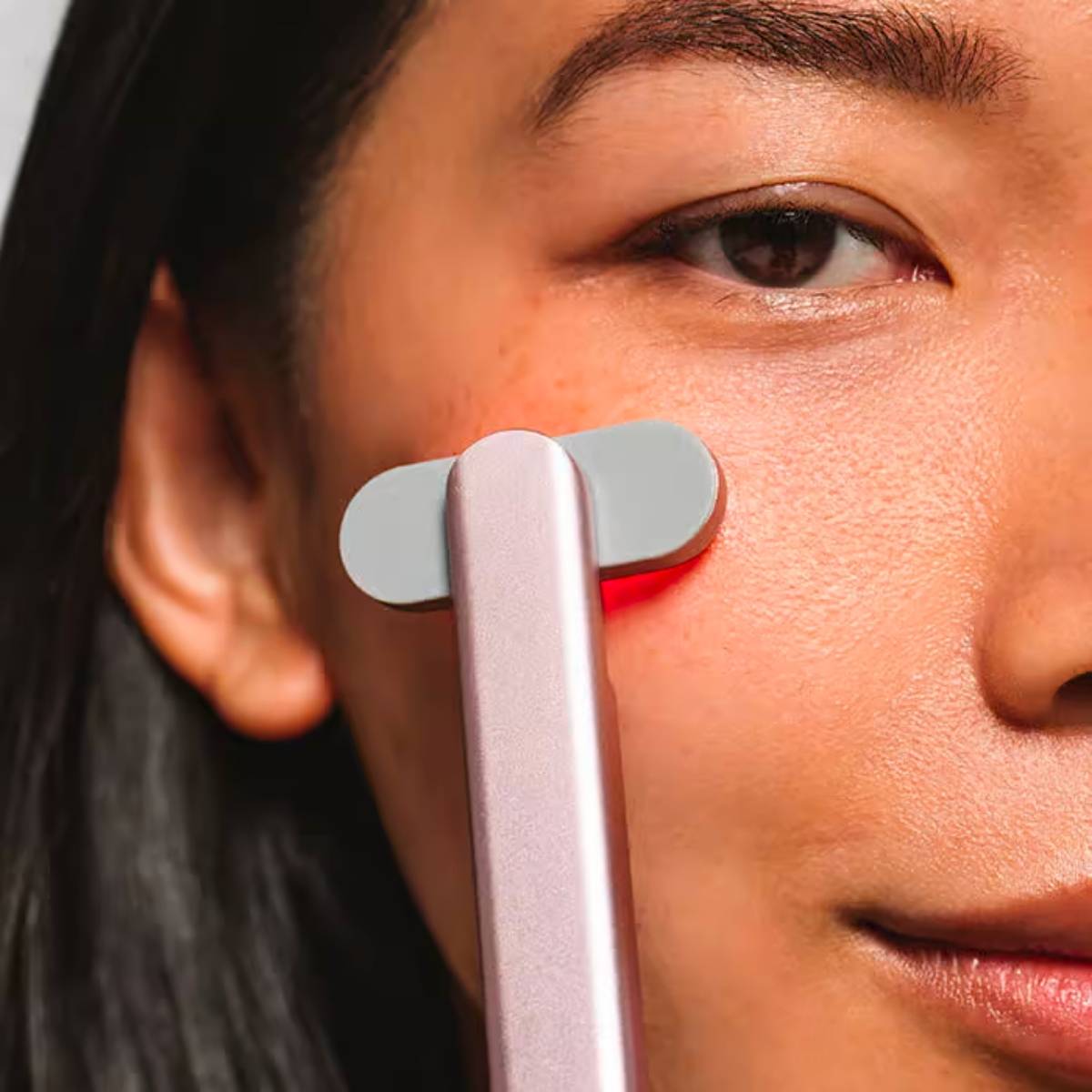 An image of a lady doing red light therapy at home