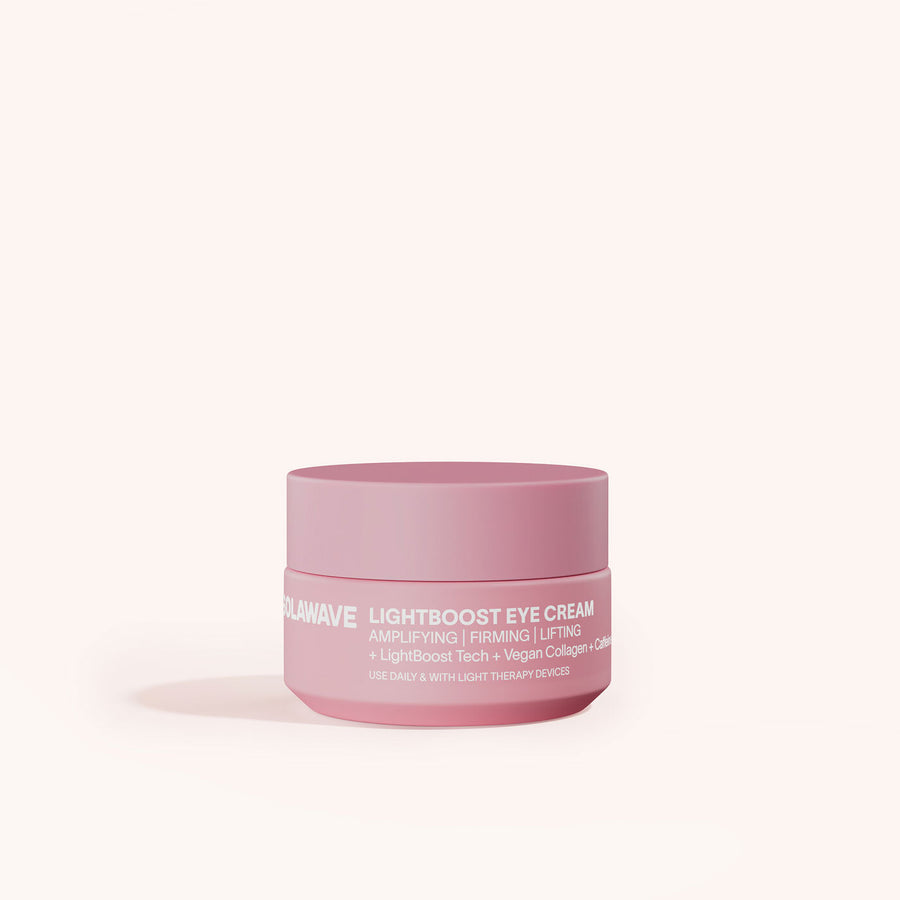 A pink jar of Solawaves LightBoost Eye Cream is elegantly set against a soft off-white background. Offering anti-aging benefits like amplifying, firming, and lifting with vegan collagen, its perfect for anyone desiring a light therapy glow in their skincare routine.