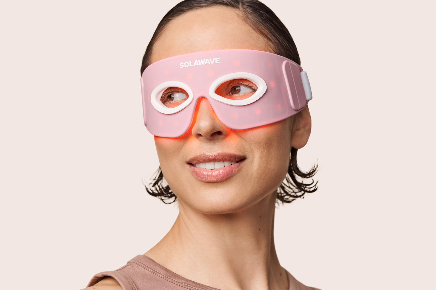An image of a woman wearing the Solawave red light therapy eye mask