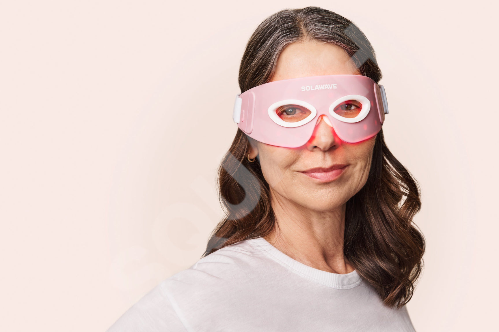 An image of a woman wearing an infrared red light therapy eye mask