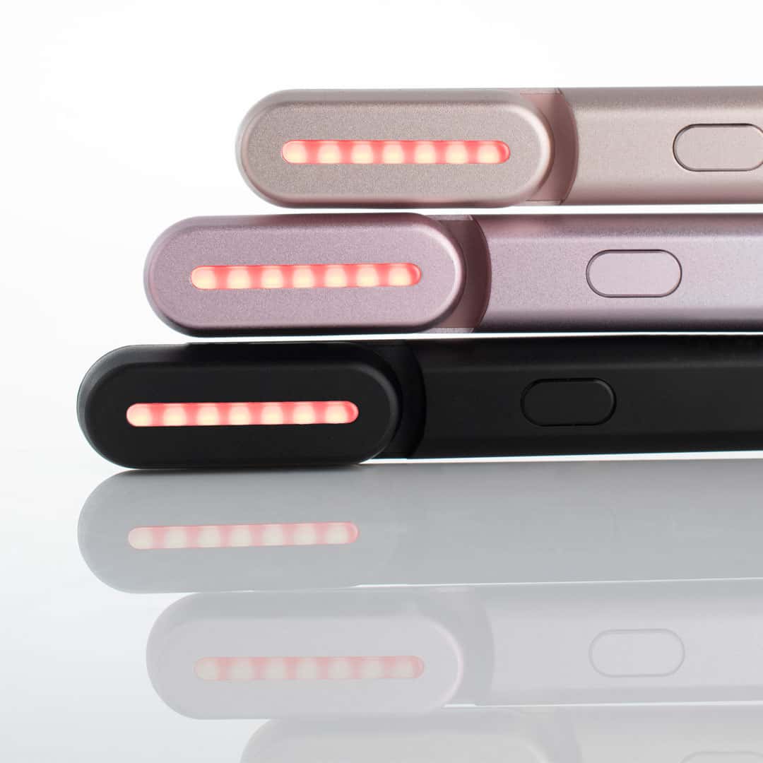 An image of three Solawave red light therapy devices on top of each other 