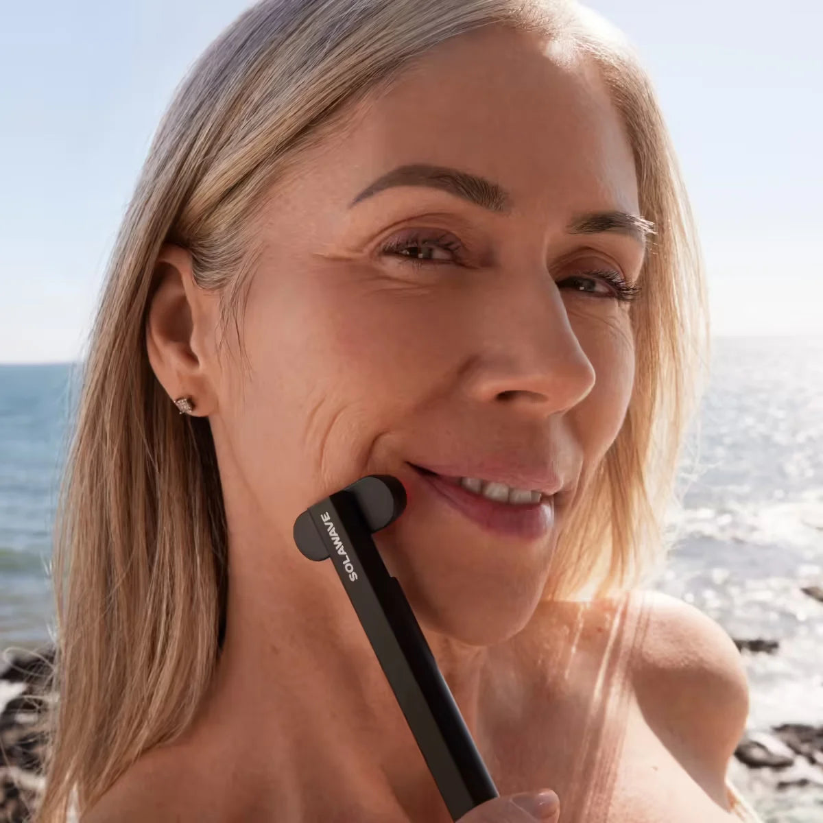 An image of a lady using the Solawave wand on her face for acne