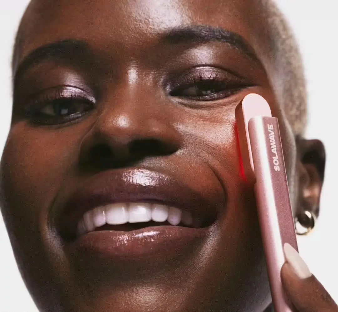 An image of a woman using red light therapy for radiant skin