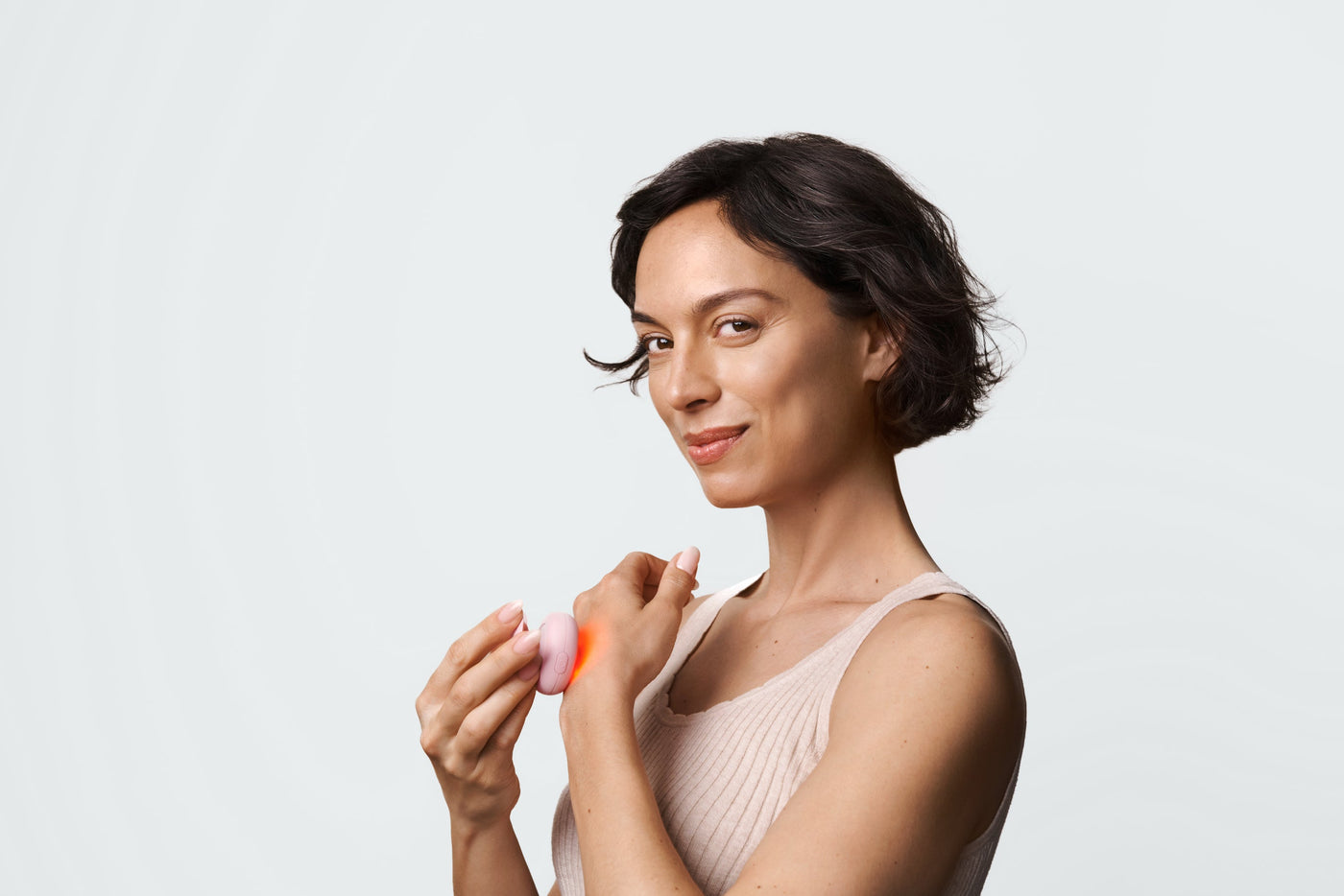 An image of a woman using red light therapy for eczema