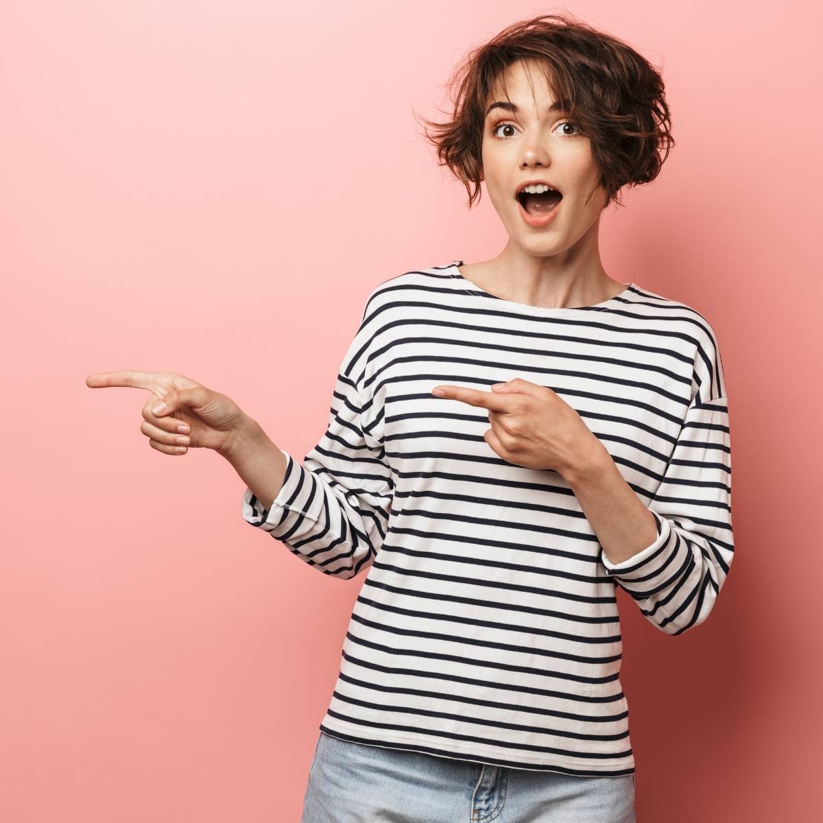 An image of a lady looking shocked and pointing to her right