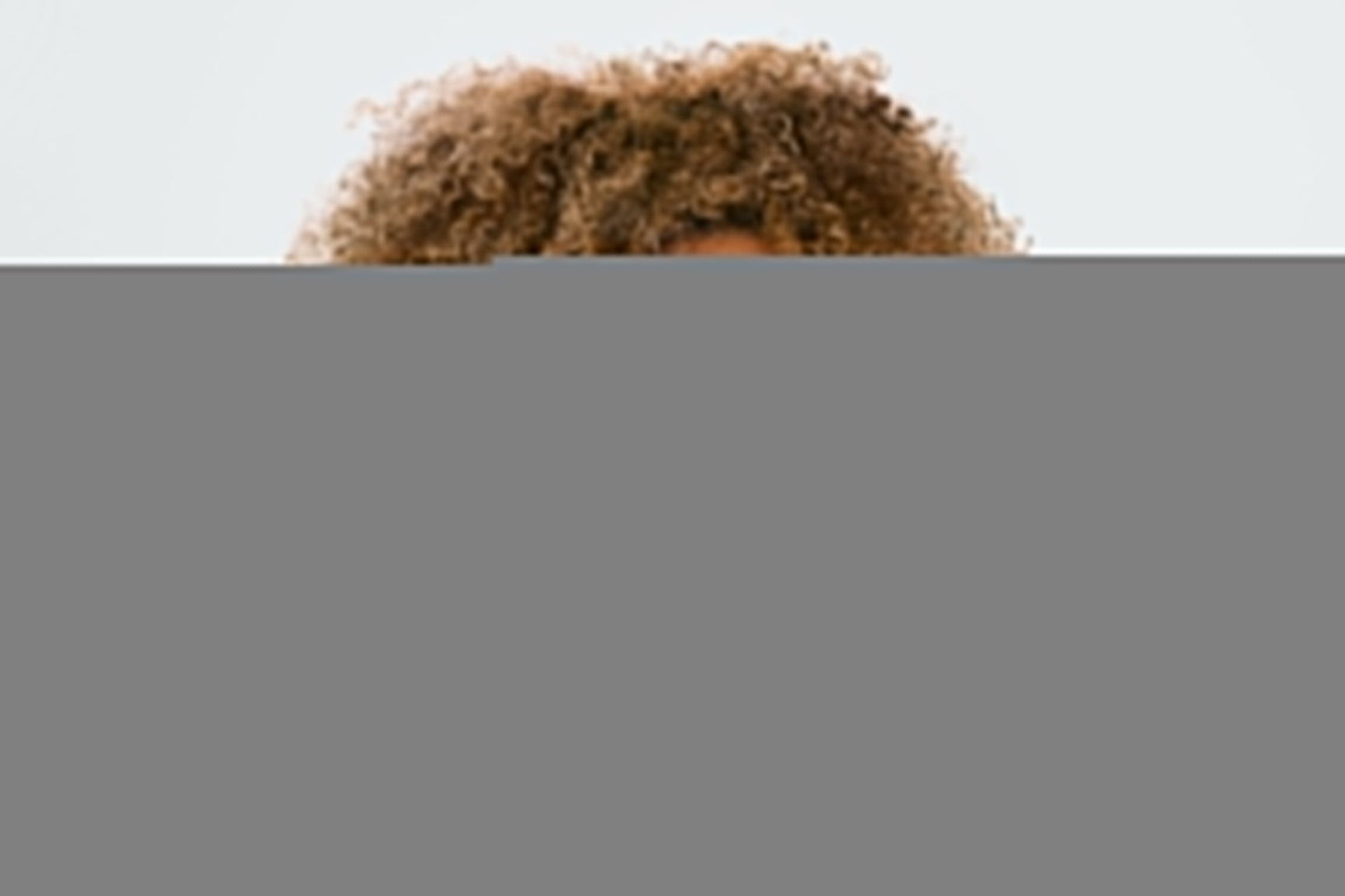 An image of a woman using red light therapy wand