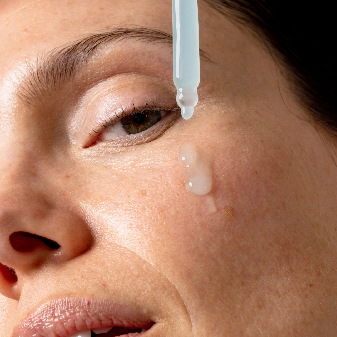 An image of a lady applying Solawave Renew Complex Activating Serum to her face || 30mL