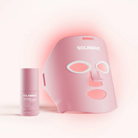 The Wrinkle Retreat Face Mask & LightBoost Serum Kit by Solawave features a rose LED mask, designed with eye, nose, and mouth cutouts for red light therapy. Paired with the pink tube of serum featuring white text, its perfect for targeting fine lines and wrinkles in a softly lit setting.