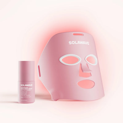 The Wrinkle Retreat Face Mask & LightBoost Serum Kit by Solawave features a rose LED mask, designed with eye, nose, and mouth cutouts for red light therapy. Paired with the pink tube of serum featuring white text, its perfect for targeting fine lines and wrinkles in a softly lit setting.
