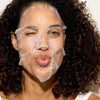 A woman with a facial sheet mask on her face