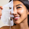 An image of a woman with a hydrating facial sheet mask on her face
