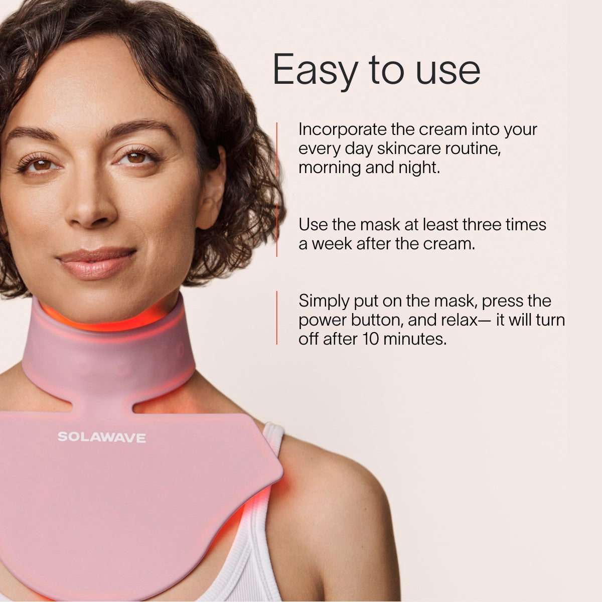 A person wearing a pink LED light therapy neck and chest mask. Text beside them reads: Solawave Neck & Chest LED Mask w/ LightBoost Cream Kit: Use the cream morning and night, then the mask 3 times a week. It turns off after 10 minutes for easy use. || Rose