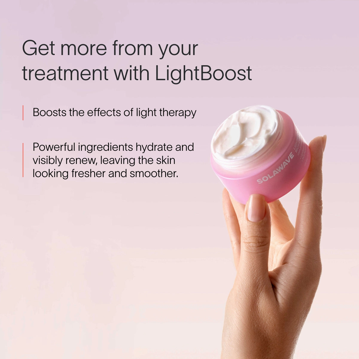 A hand holds a pink jar from the Neck & Chest LED Mask w/ LightBoost Cream Kit by Solawave against a soft pink background. Text reads: Enhance your routine with LightBoost. Boost red light therapy effects; powerful ingredients hydrate and renew, leaving skin looking fresher and smoother. || Rose
