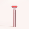The Solawave 4-in-1 Radiant Renewal Skincare Wand Bundle, a sleek pink handheld device with a rectangular LED light head and single button, displays "SW" at the base and stands upright against a light background.