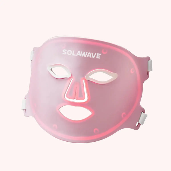 Pink LED face mask with glowing red light therapy panels across forehead, nose bridge, and mouth area.