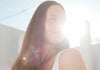 Solawave red light therapy neck and chest mask being used to treat sun damage, loss of elasticity, and uneven tone.