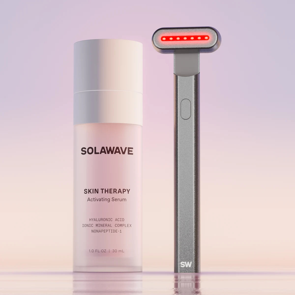 The Solawave 4-in-1 Red Light Therapy Skincare Wand & Activating Serum Kit, in a charcoal hue, features a Radiant Renewal Wand with red LED lights and serum rich in hyaluronic acid for revitalized skin against a gradient backdrop. || Charcoal
