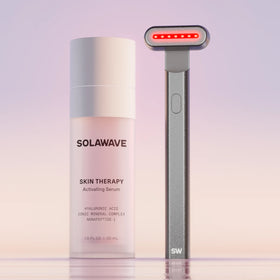 The Solawave 4-in-1 Red Light Therapy Skincare Wand & Activating Serum Kit, in a charcoal hue, features a Radiant Renewal Wand with red LED lights and serum rich in hyaluronic acid for revitalized skin against a gradient backdrop. || Charcoal