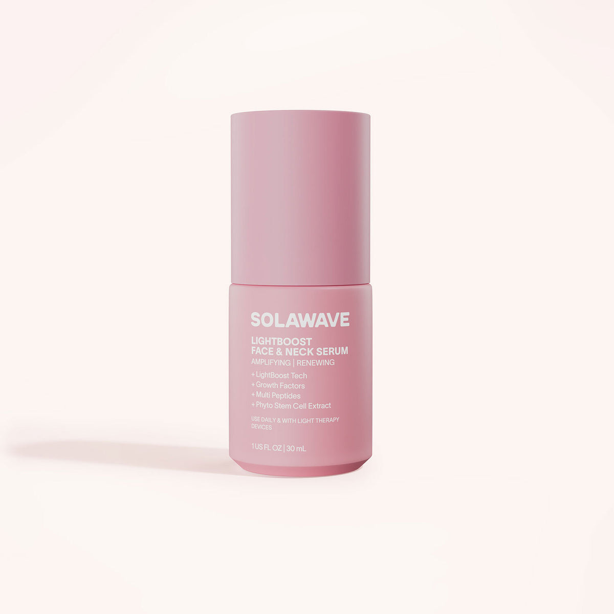 A pink bottle of Solawaves LightBoost Face & Neck Serum sits against a pale background, highlighting its benefits: lightweight, rich, smooths fine lines with a LightBoost Complex and plant-based components. Capacity is 1 fl. oz. (30 ml).