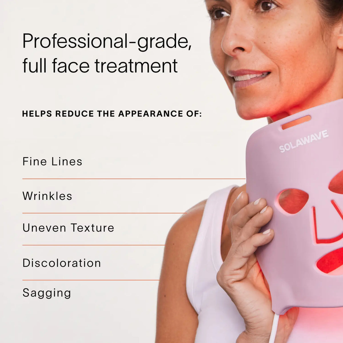A person holds a pink LED face mask labeled Solawave near their face, captioned: Wrinkle Retreat Face Mask & LightBoost Cream Kit offers professional-grade red light therapy to reduce fine lines, wrinkles, uneven texture, discoloration, and sagging by boosting collagen production.